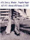 A/2C Jerry Wheeler holds up a palm tree, AST#5, Panama, 1957